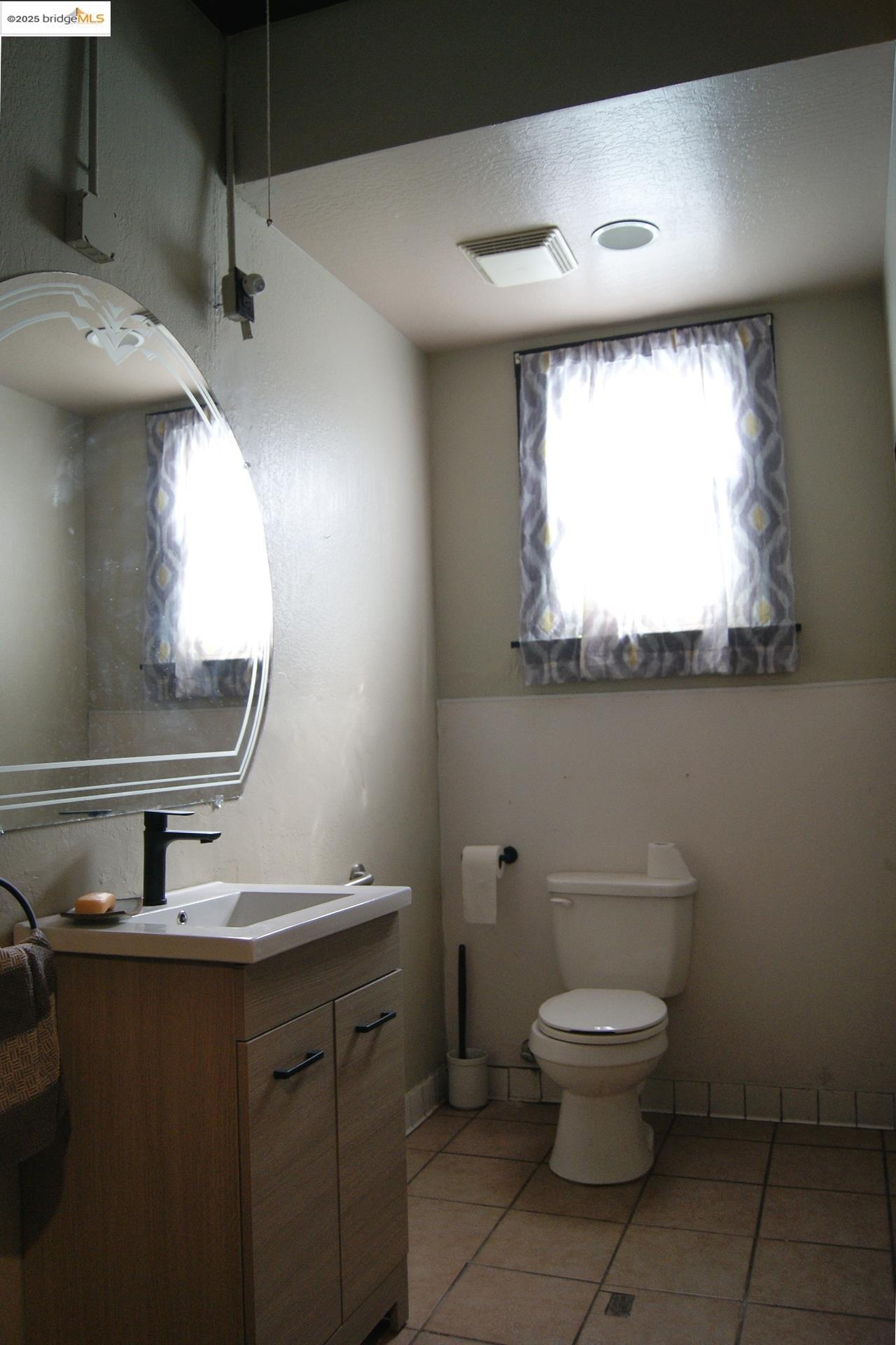 58 Main Street Isleton, CA 95641 - Photo 7 of 10 a bathroom with a toilet sink and mirror