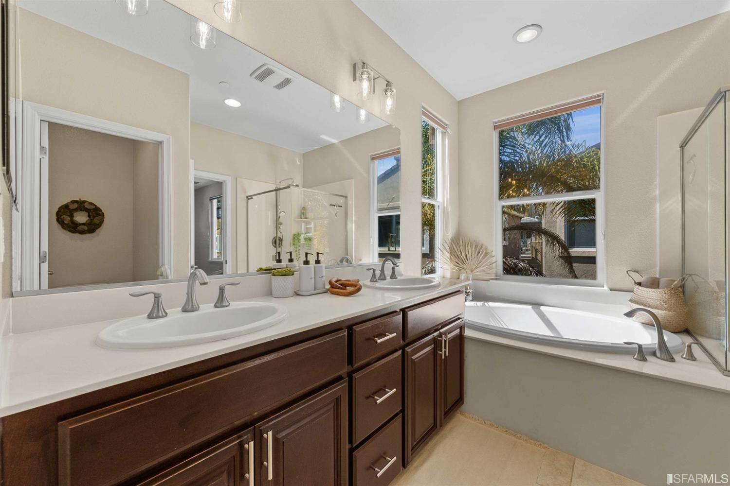 3547 Meyer Place Santa Clara, CA 95051 - Photo 14 of 34 a bathroom with double vanity sinks a large mirror and a bathtub