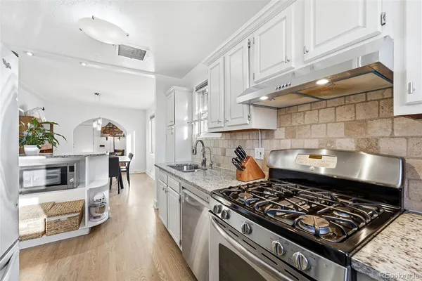a kitchen with stove and cabinets