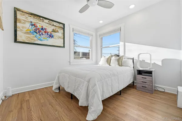 a bedroom with a bed and a painting on the wall
