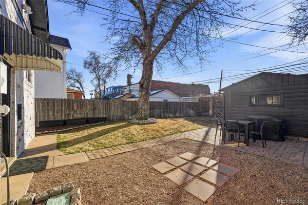 a view of a backyard with sitting area