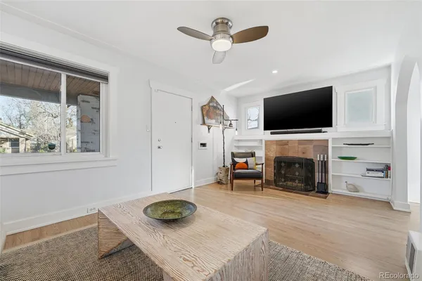 a living room with furniture and a fireplace