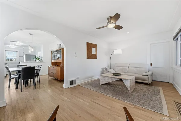 a living room with furniture and a wooden floor