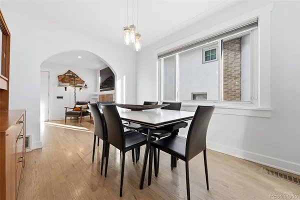 a view of a dining room with furniture and chandelier