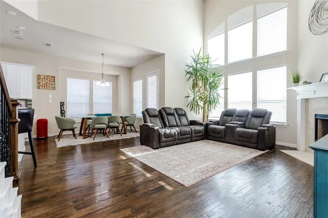 a living room with furniture wooden floor and a large window