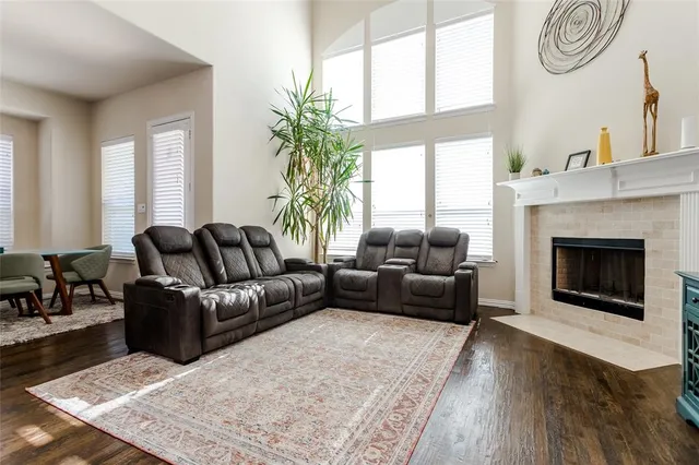 a living room with furniture a large window and a fireplace