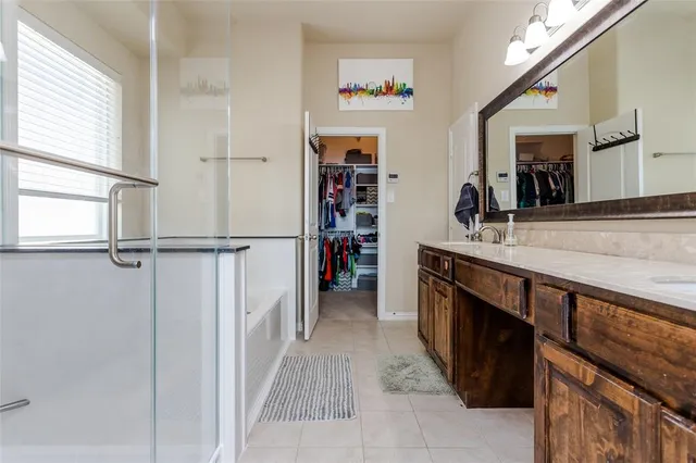 a spacious bathroom with a sink a bathtub and a window