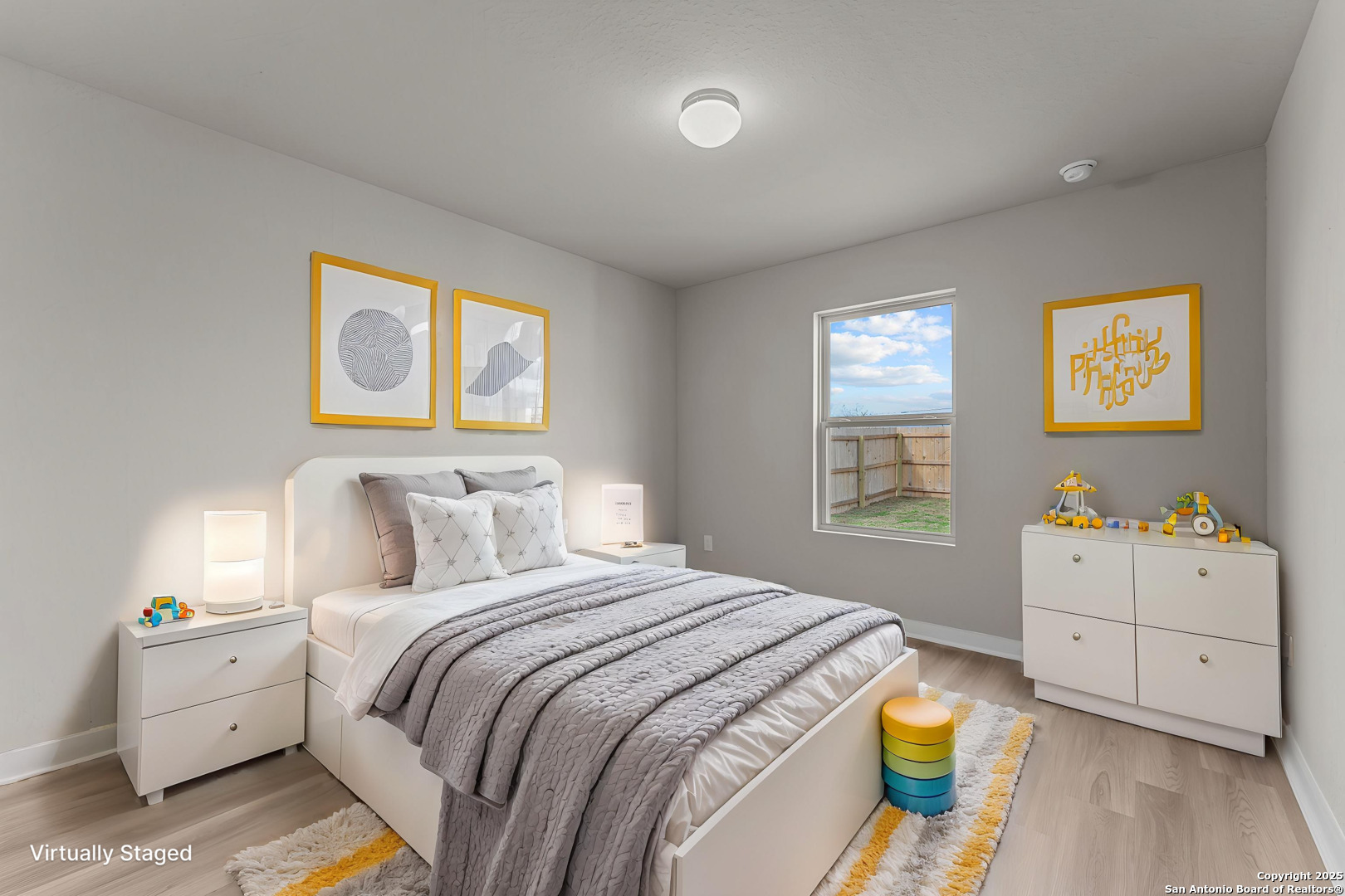 8626 Rucker Pond Trail San Antonio, TX 78252 - Photo 16 of 24 a bedroom with a bed and paintings on the dresser