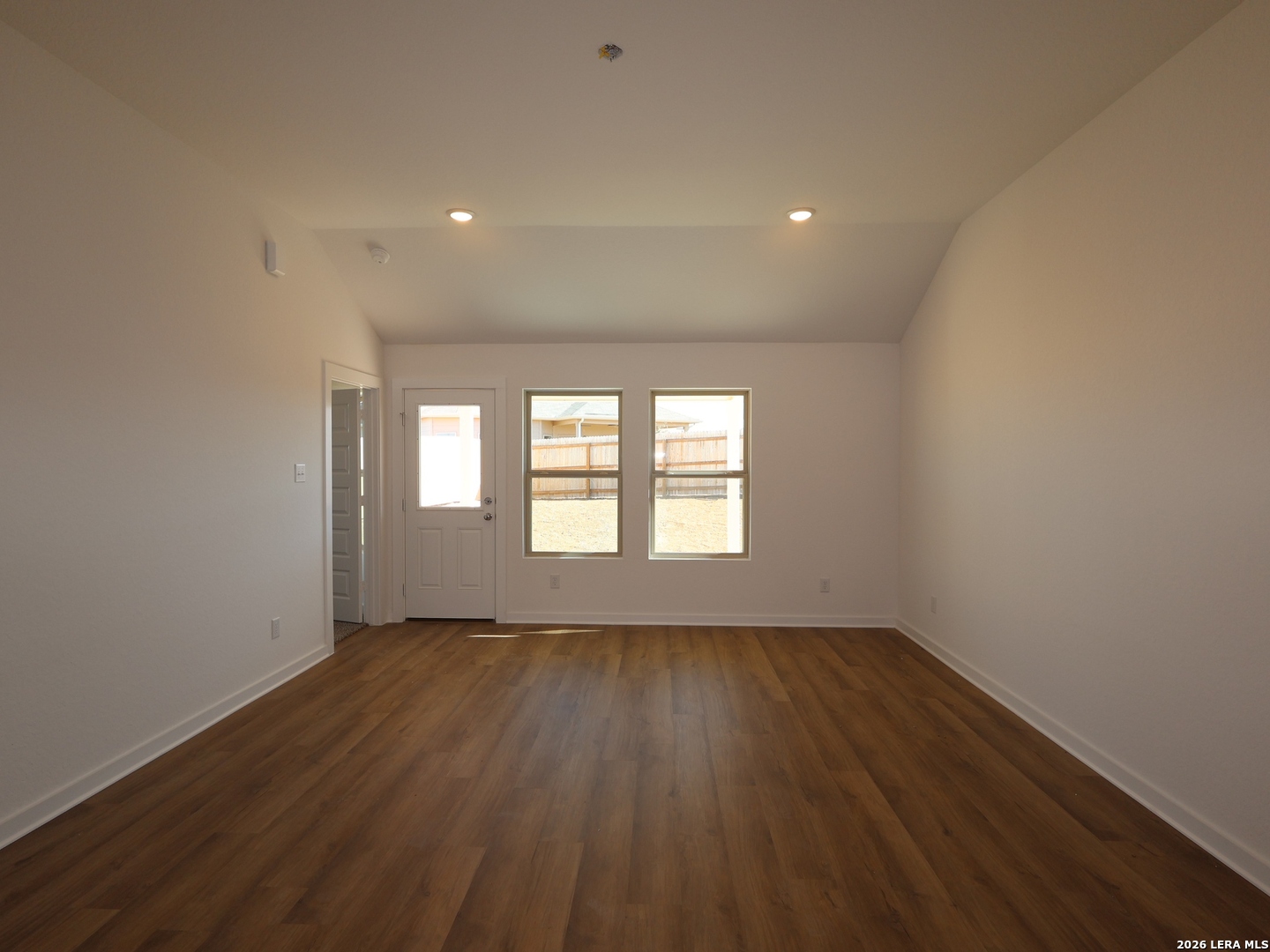 8626 Rucker Pond Trail San Antonio, TX 78252 - Photo 5 of 24 a view of an empty room with wooden floor and a window
