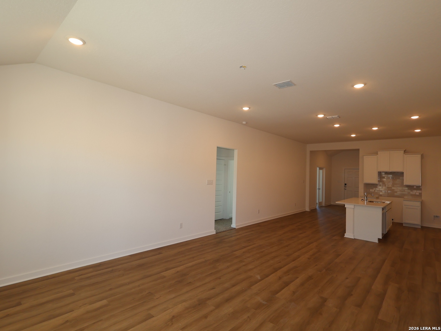 8626 Rucker Pond Trail San Antonio, TX 78252 - Photo 6 of 24 a view of a kitchen with a sink and dishwasher with wooden floor