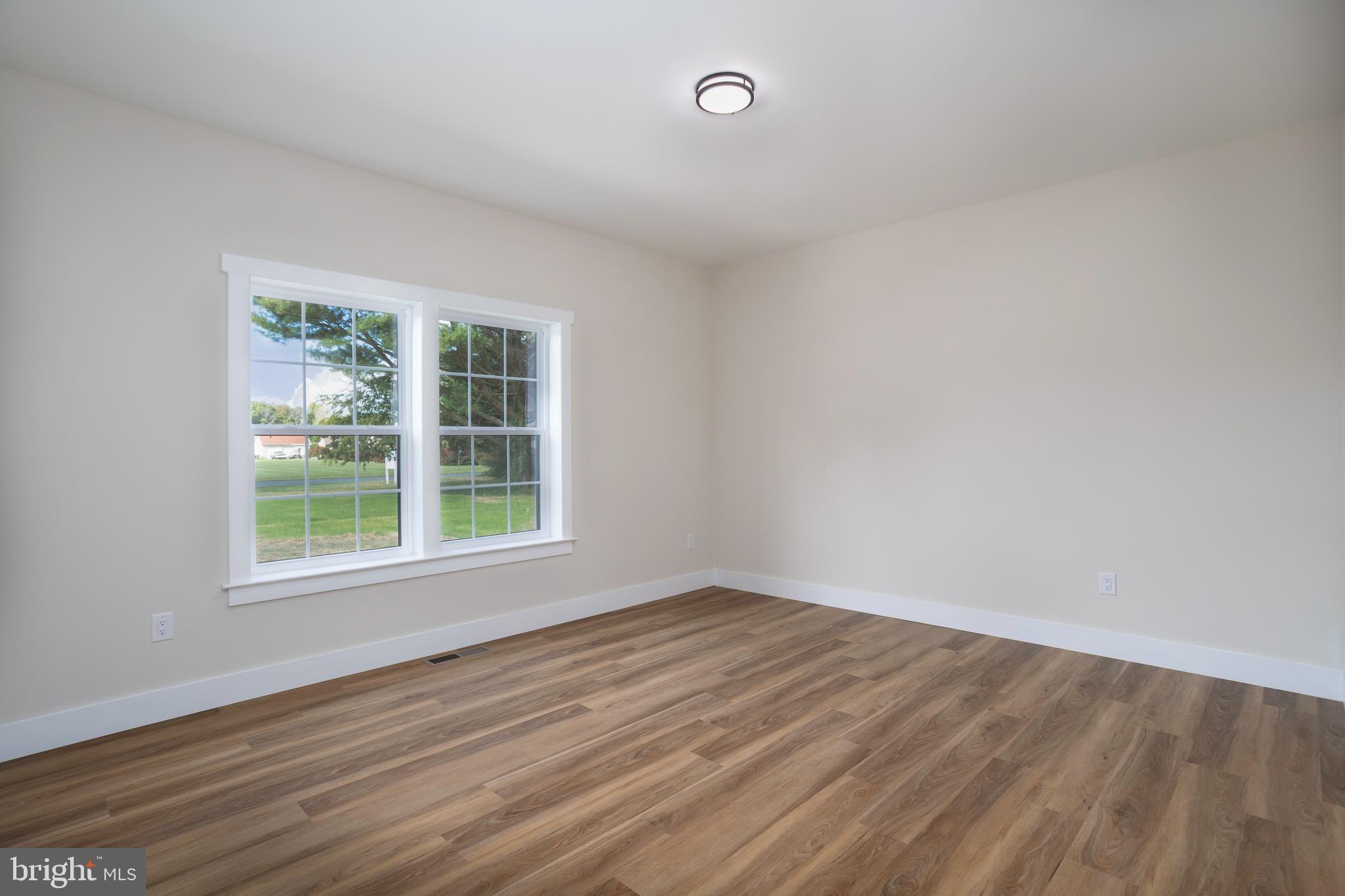 Clark Corner Road Centreville, MD 21617 - Photo 8 of 43 an empty room with wooden floor and windows