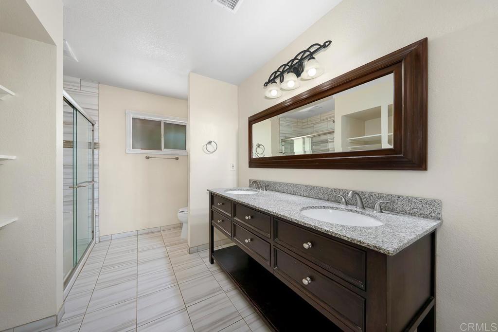 2073 Valley Rim Road El Cajon, CA 92019 - Photo 11 of 20 a bathroom with a toilet sink and mirror