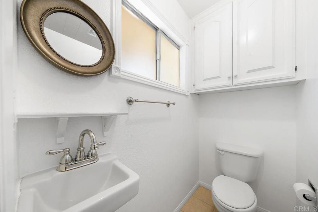 2073 Valley Rim Road El Cajon, CA 92019 - Photo 13 of 20 a bathroom with a sink a toilet and a mirror