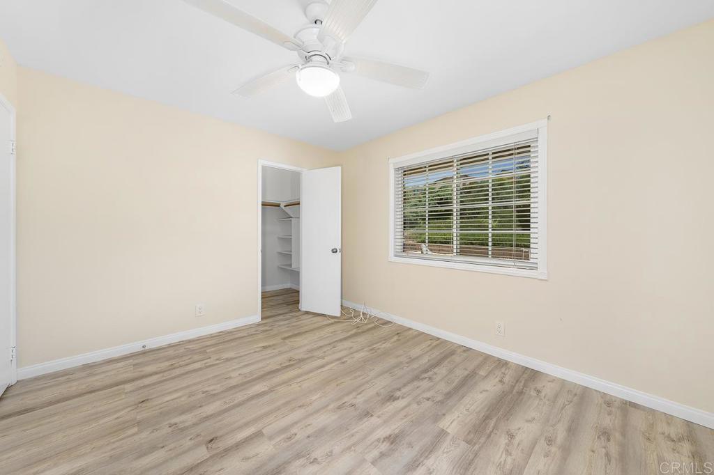2073 Valley Rim Road El Cajon, CA 92019 - Photo 15 of 20 an empty room with wooden floor cabinet and windows