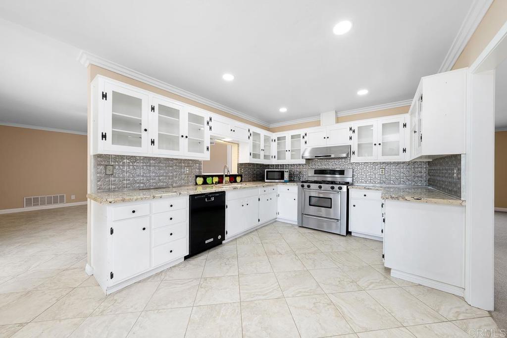 2073 Valley Rim Road El Cajon, CA 92019 - Photo 3 of 20 a kitchen with granite countertop white cabinets and white stainless steel appliances