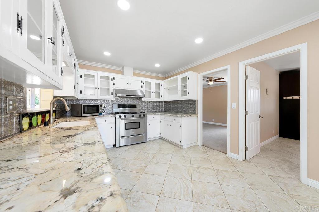 2073 Valley Rim Road El Cajon, CA 92019 - Photo 4 of 20 a kitchen with stainless steel appliances granite countertop a stove a sink and a refrigerator