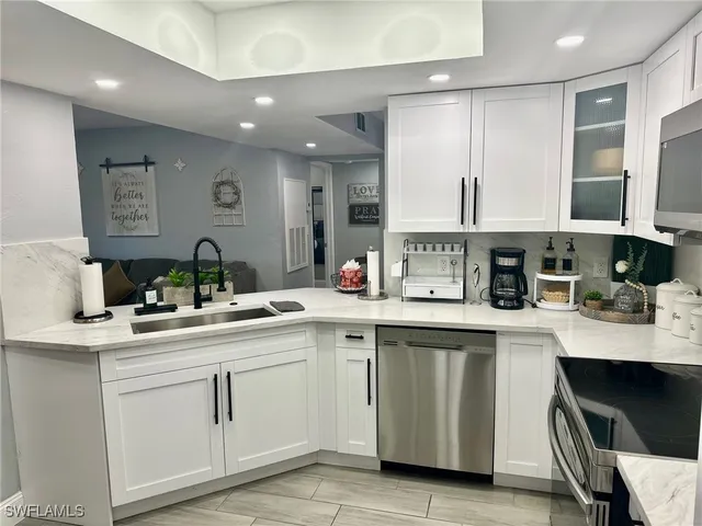 a kitchen with a sink stove and cabinets