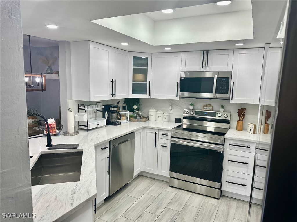 3100 Seasons Way, Unit 108 Estero, FL 33928 - Photo 12 of 40 a kitchen with a sink stove and microwave