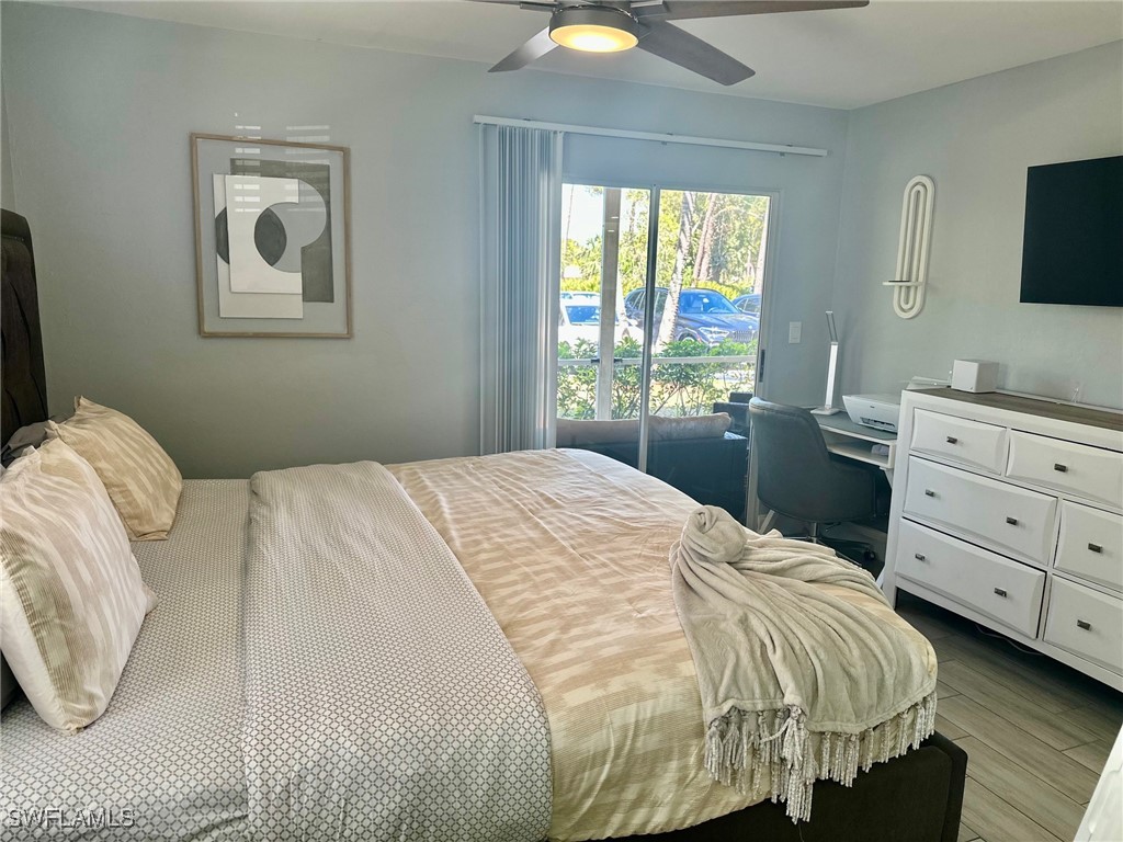3100 Seasons Way, Unit 108 Estero, FL 33928 - Photo 16 of 40 a bedroom with a bed and a flat screen tv