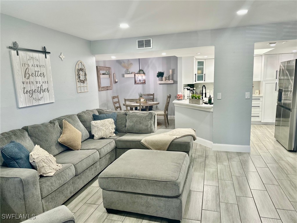 3100 Seasons Way, Unit 108 Estero, FL 33928 - Photo 2 of 40 a living room with furniture and a rug