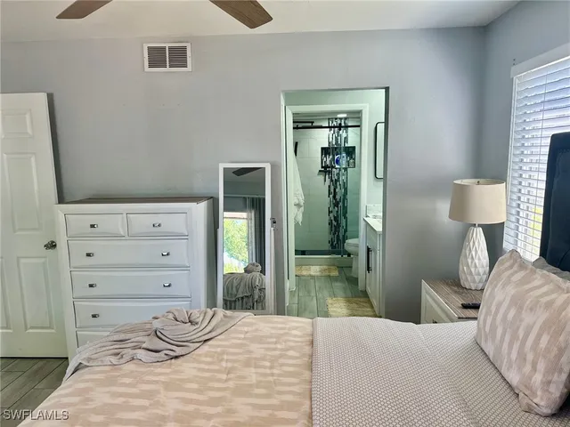 a bedroom with a bed and a mirror