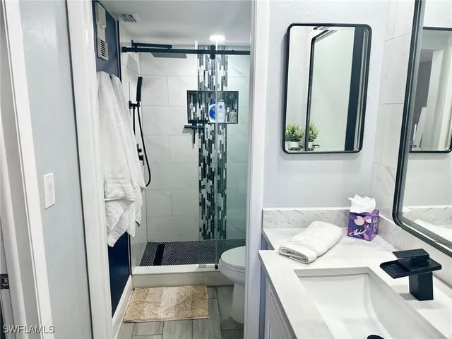 a bathroom with a tub sink and mirror