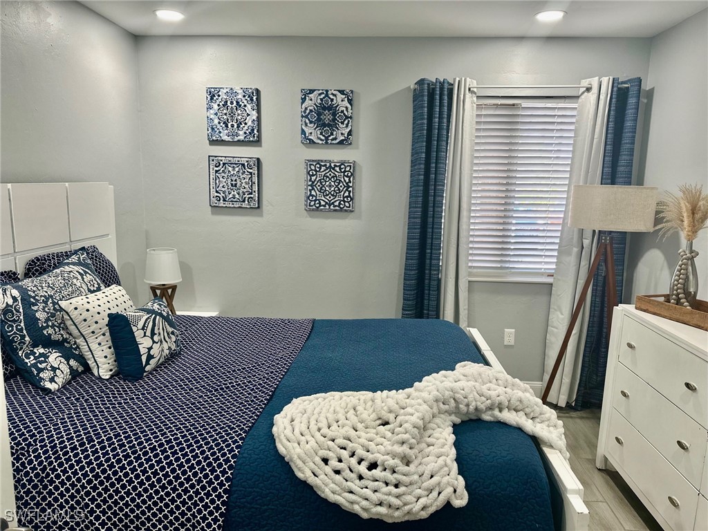 3100 Seasons Way, Unit 108 Estero, FL 33928 - Photo 25 of 40 a bedroom with a bed and a dresser