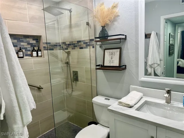 a bathroom with a toilet sink and shower