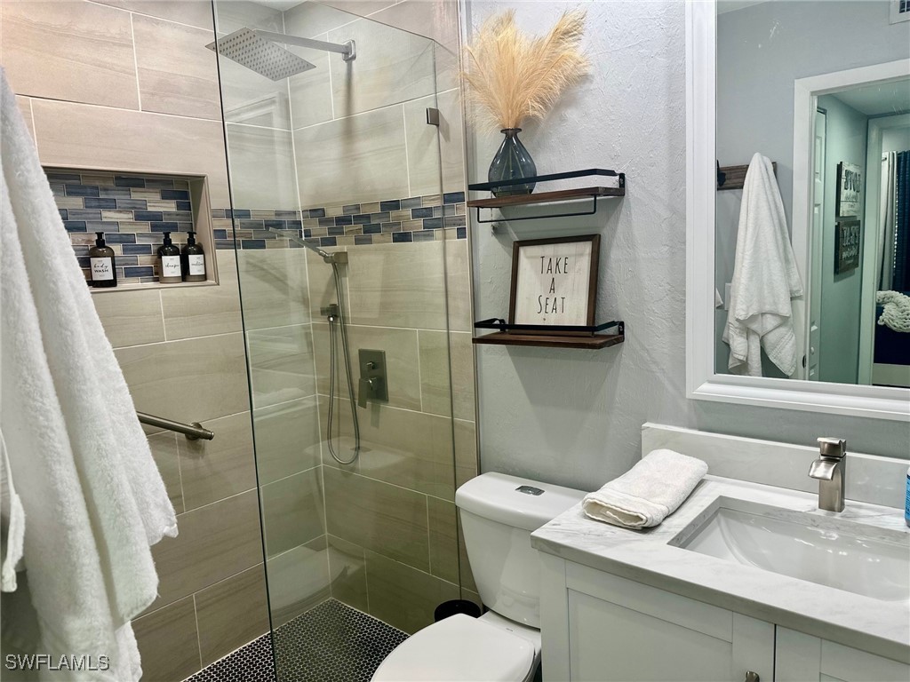 3100 Seasons Way, Unit 108 Estero, FL 33928 - Photo 27 of 40 a bathroom with a toilet sink and shower