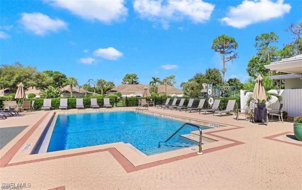 3100 Seasons Way, Unit 108 Estero, FL 33928 - Photo 37 of 40 a view of swimming pool with outdoor seating and city view