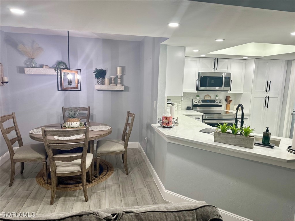 3100 Seasons Way, Unit 108 Estero, FL 33928 - Photo 8 of 40 a dining room with furniture and window