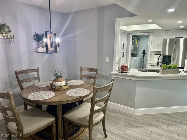 a view of a dining room with furniture and chandelier