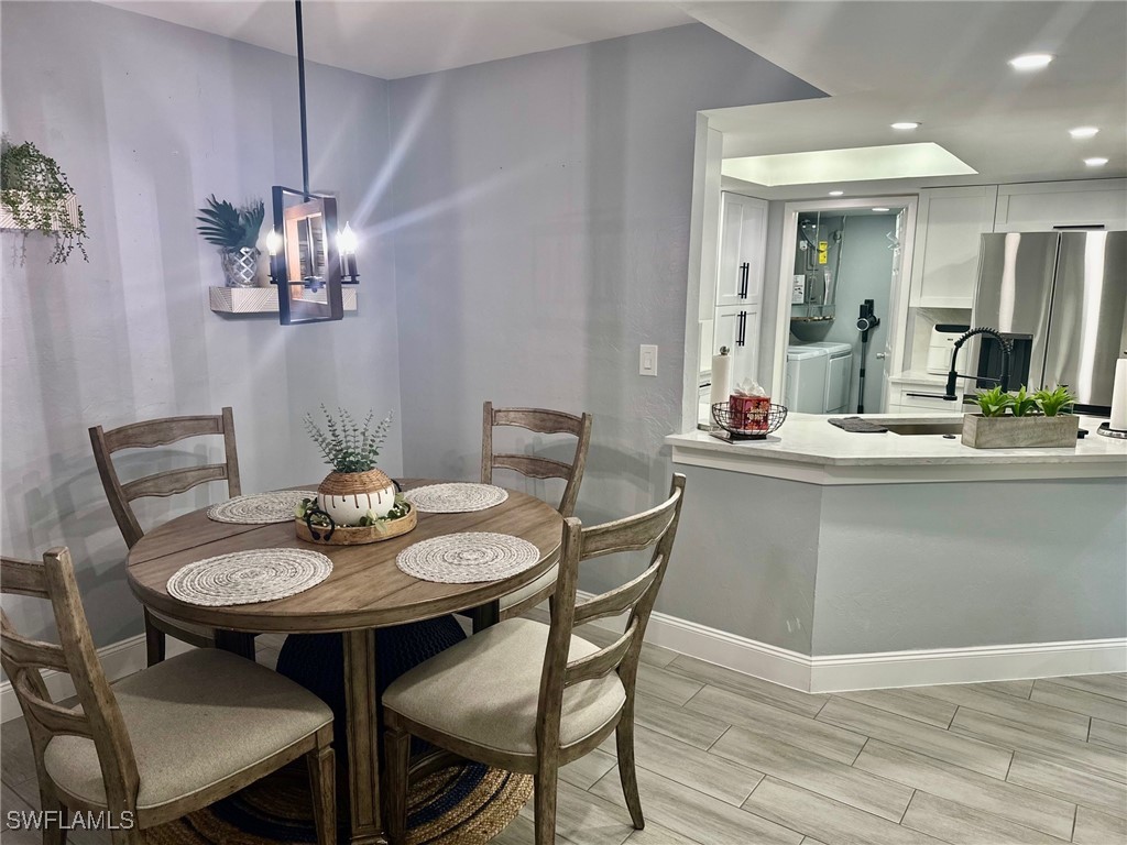 3100 Seasons Way, Unit 108 Estero, FL 33928 - Photo 9 of 40 a view of a dining room with furniture and chandelier