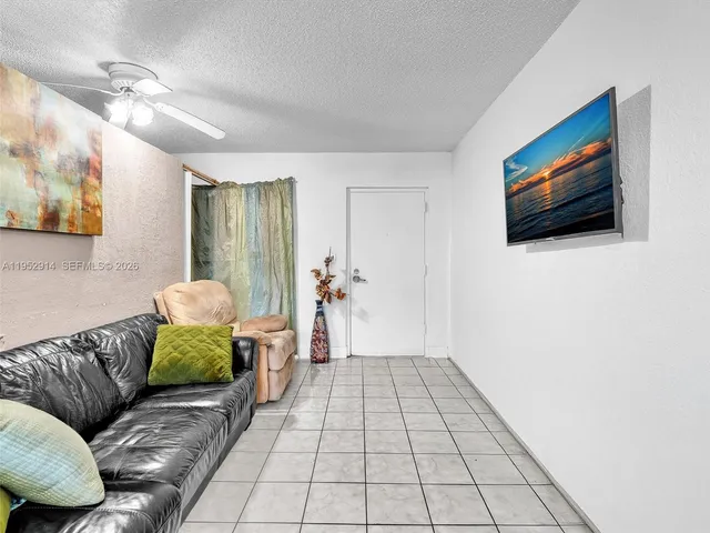 a view of a kitchen with a refrigerator and furniture