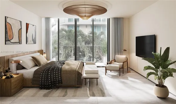 a living room with furniture ceiling fan and a large window