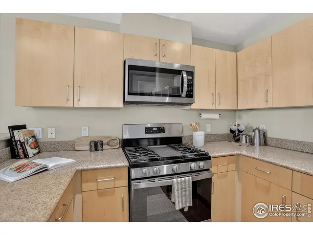 a kitchen with kitchen island a refrigerator and a stove top oven