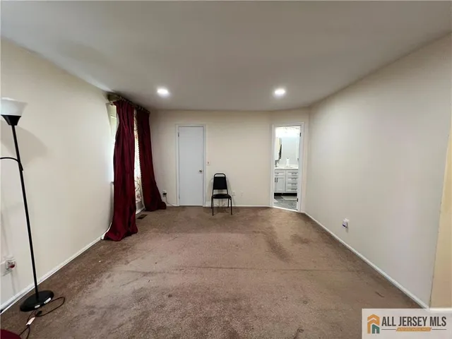 a bathroom with a tub a sink and a mirror