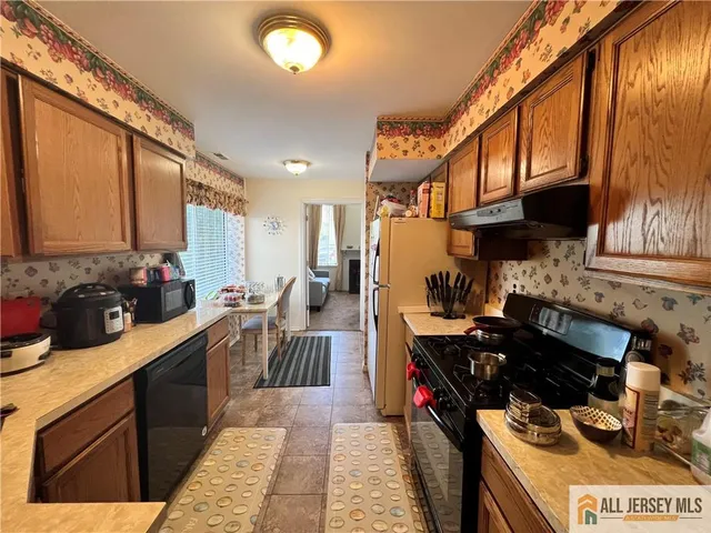 a kitchen with a stove a sink and a refrigerator