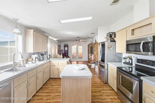 a kitchen with a stove a sink and a refrigerator