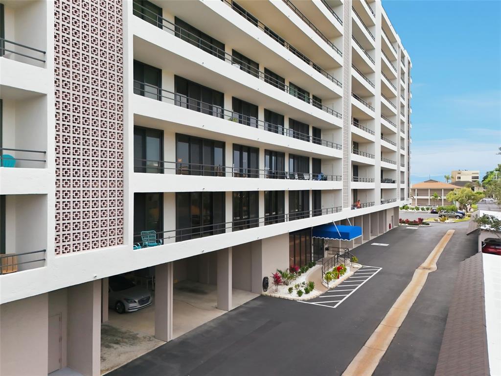 6415 Midnight Pass Road, Unit 211 Sarasota, FL 34242 - Photo 1 of 58 a view of a balcony with wooden floor and fence