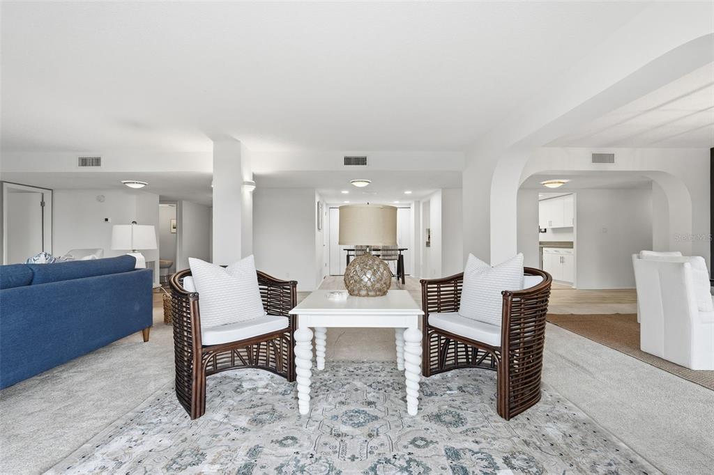 6415 Midnight Pass Road, Unit 211 Sarasota, FL 34242 - Photo 12 of 58 a living room with furniture and a wooden floor
