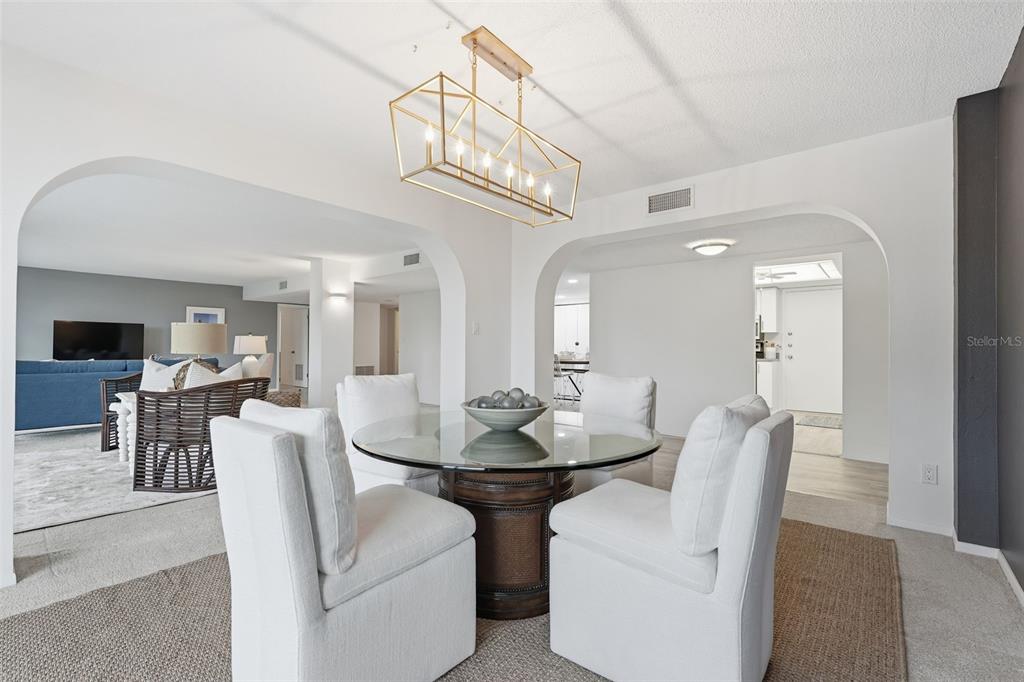 6415 Midnight Pass Road, Unit 211 Sarasota, FL 34242 - Photo 14 of 58 a view of a dining room with furniture and a chandelier