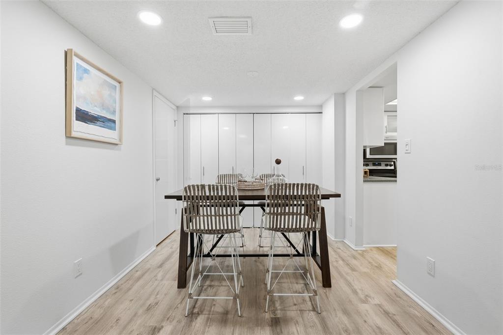 6415 Midnight Pass Road, Unit 211 Sarasota, FL 34242 - Photo 15 of 58 a view of a workspace with furniture and wooden floor