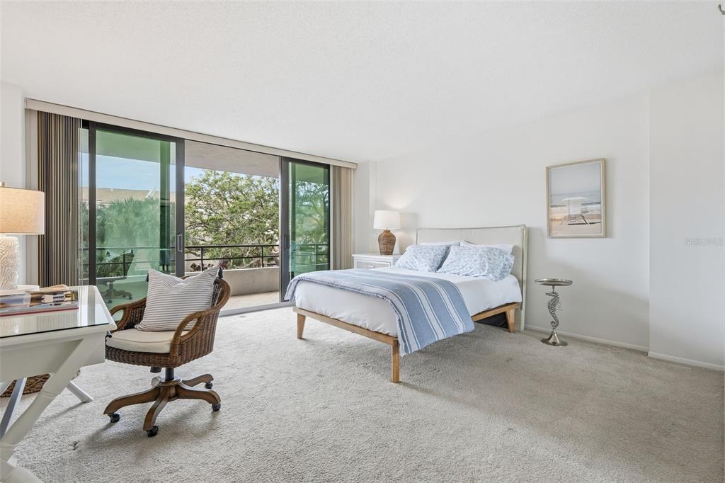 6415 Midnight Pass Road, Unit 211 Sarasota, FL 34242 - Photo 29 of 58 a bedroom with a bed and large windows