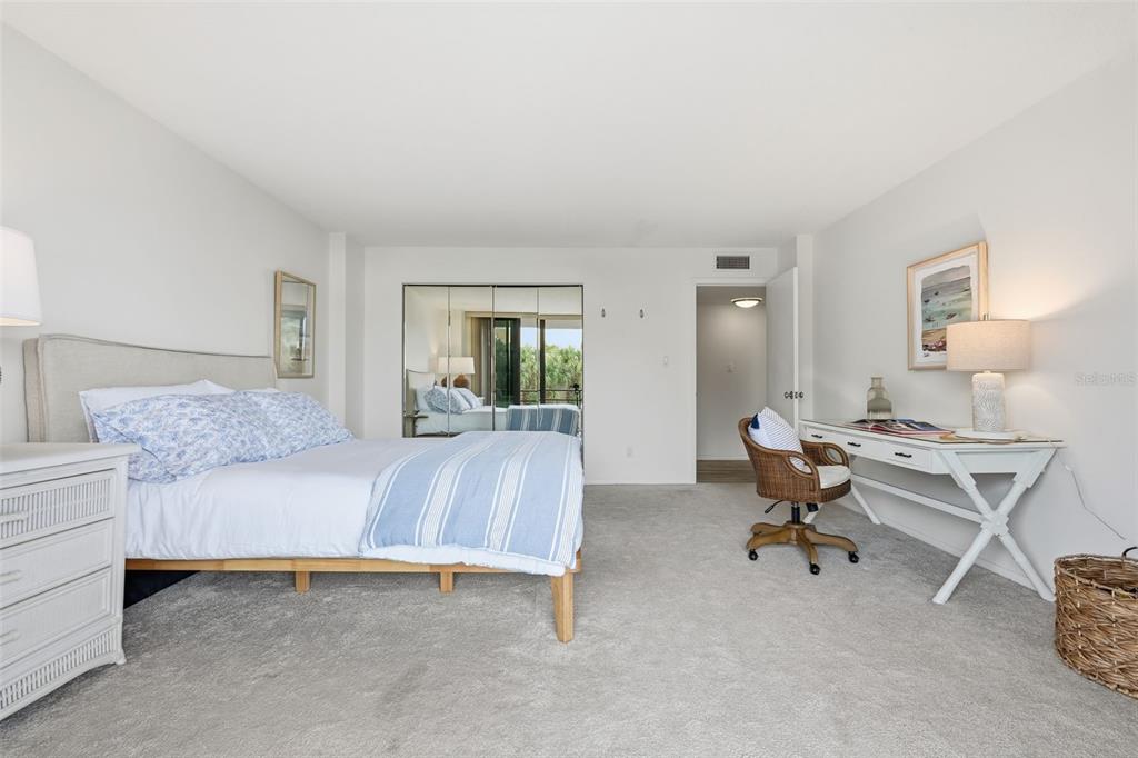 6415 Midnight Pass Road, Unit 211 Sarasota, FL 34242 - Photo 31 of 58 a living room with furniture and a potted plant on table