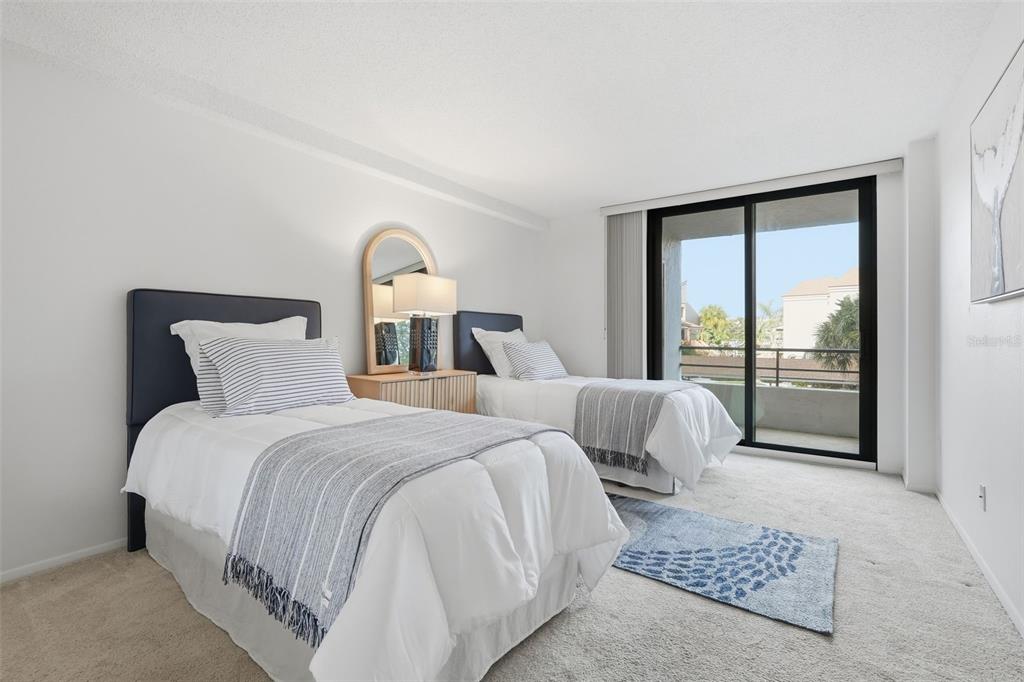 6415 Midnight Pass Road, Unit 211 Sarasota, FL 34242 - Photo 32 of 58 a bedroom with a bed and a large window