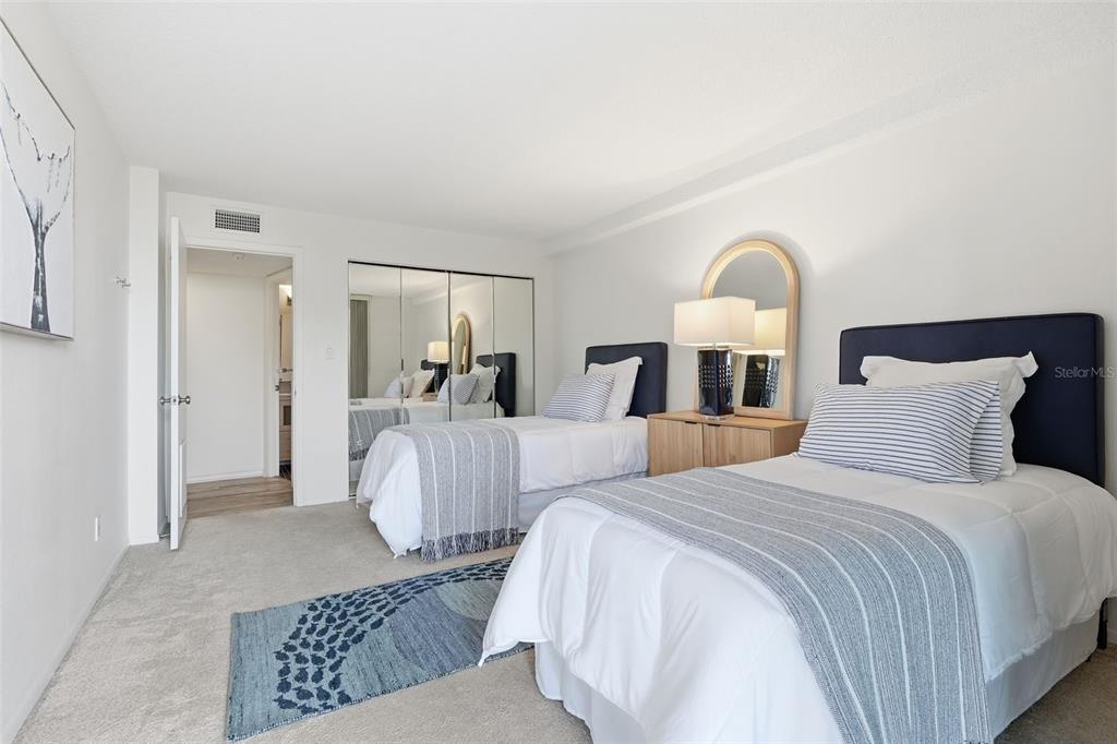 6415 Midnight Pass Road, Unit 211 Sarasota, FL 34242 - Photo 33 of 58 a bed room with two twin beds and a couch