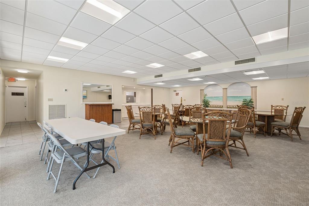 6415 Midnight Pass Road, Unit 211 Sarasota, FL 34242 - Photo 38 of 58 a room with lots of furniture and a projector screen