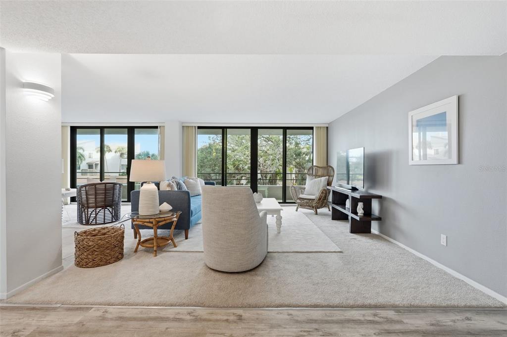 6415 Midnight Pass Road, Unit 211 Sarasota, FL 34242 - Photo 5 of 58 a living room with furniture tv and a large window