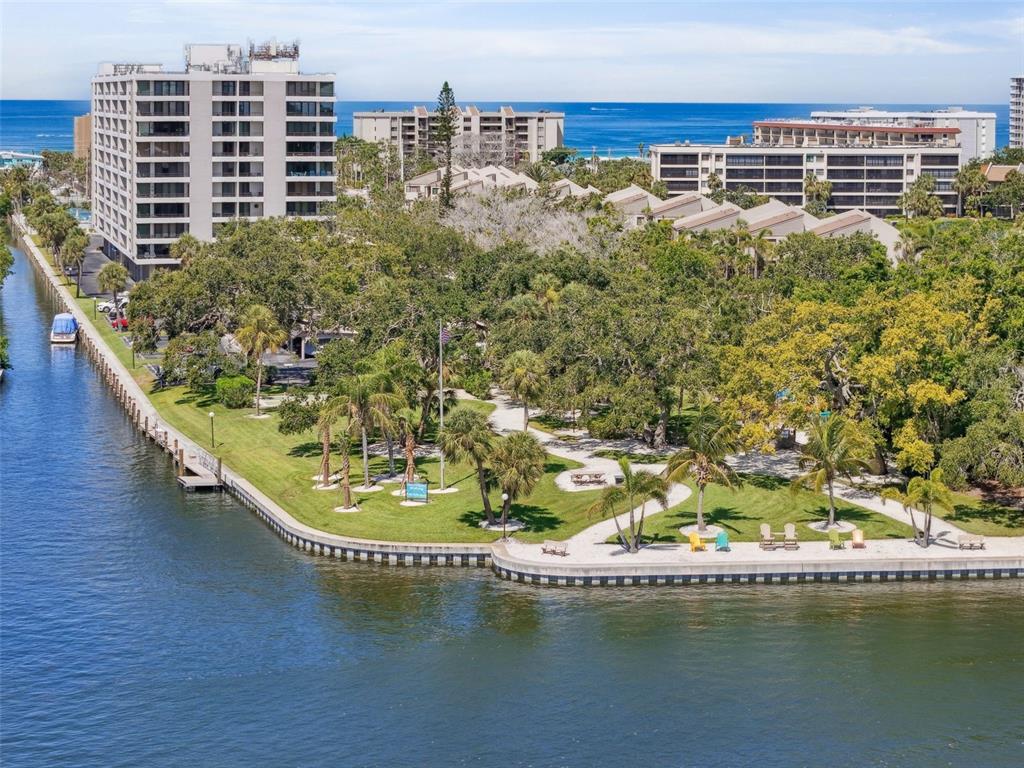 6415 Midnight Pass Road, Unit 211 Sarasota, FL 34242 - Photo 55 of 58 a view of a lake with a city skyline in the background